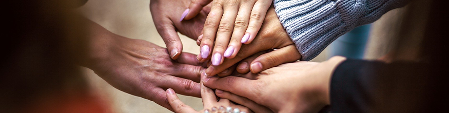 Group of hands stacked together in the middle